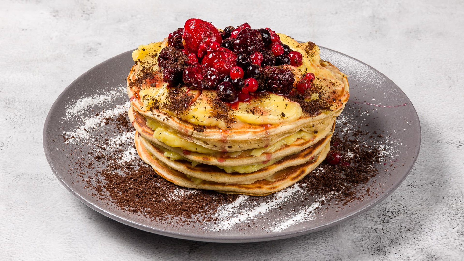 Pancakes with pastry cream and forest fruits